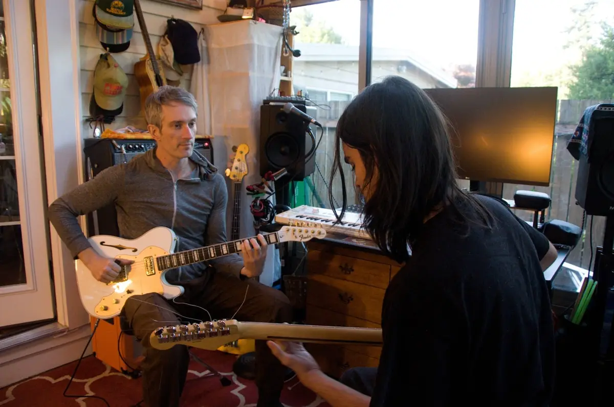 Chris teaching a student electric guitar in his West Seattle home studio