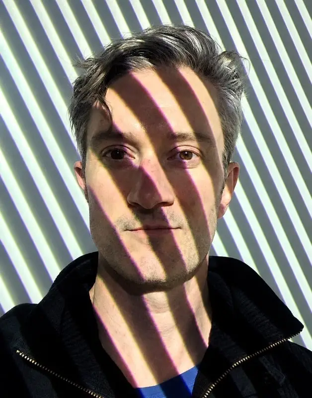 Portrait of Chris Flanders with striped window light